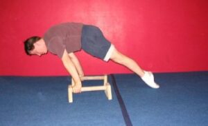 Planche leans on parallettes