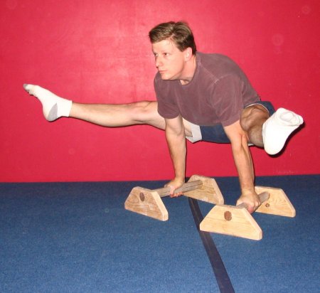 Roger Harrell demonstrating a Straddle L with the knees above the elbows (Very difficult).
